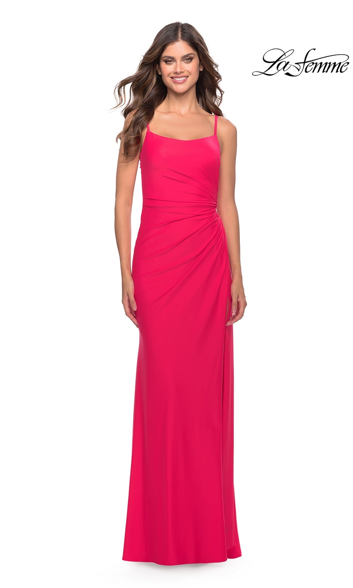 A woman poses against a white background in the La Femme Side-Slit Backless Long Prom Dress 31329—a sleeveless, floor-length bright pink gown with thin straps and ruched side detailing. The La Femme logo appears in the top right corner.